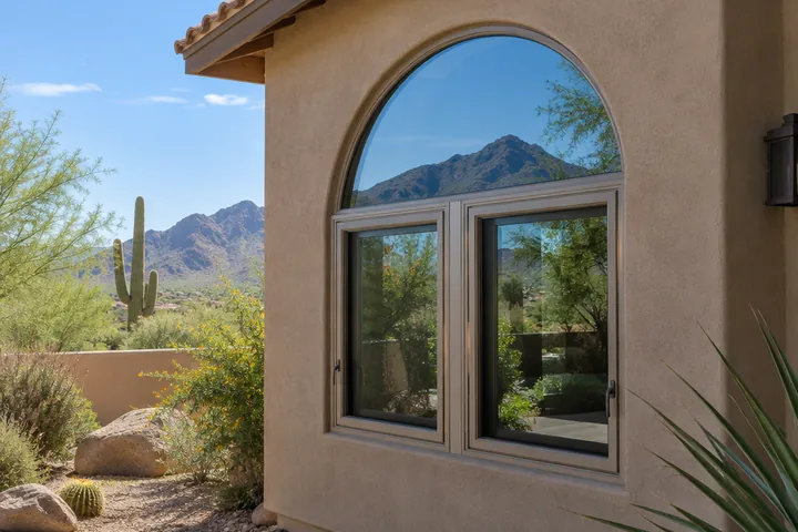 Arched window above a pair of casement windows